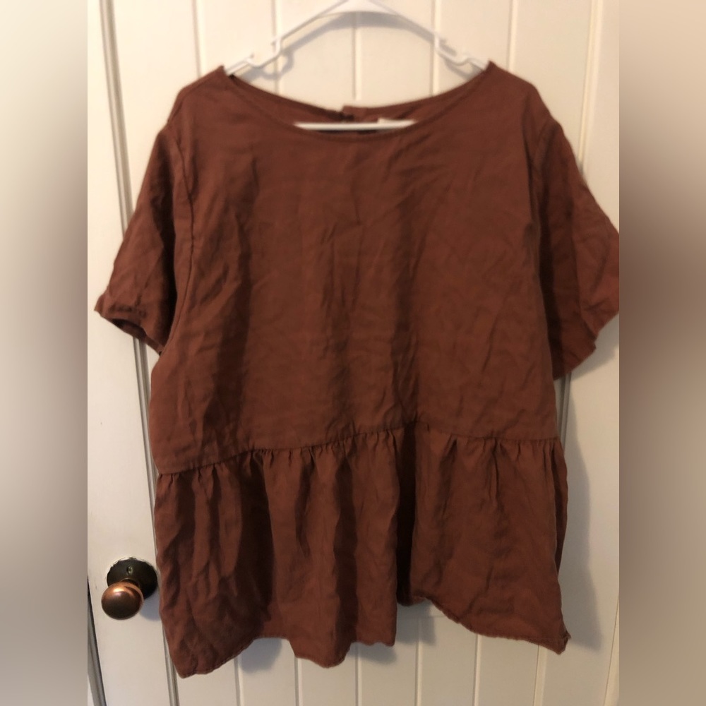 Tradland’s Nico Short Sleeve Peplum in the color Plum. Size is 2x.